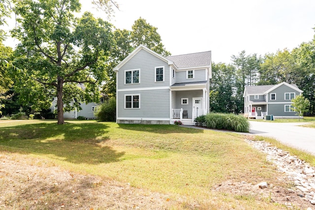 view of front property with a front yard and central air condition unit