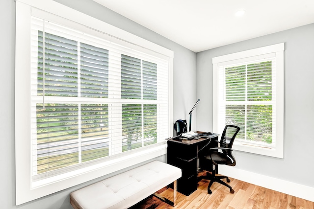 office with plenty of natural light and light wood-type flooring