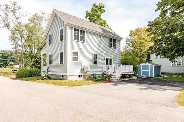 back of property with a storage unit