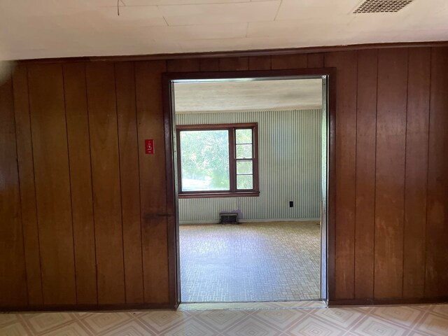 hall featuring wood walls