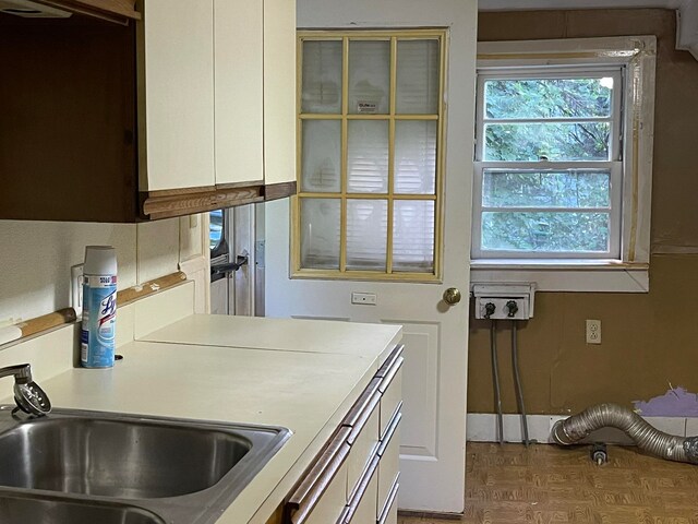 kitchen featuring sink and white cabinetry