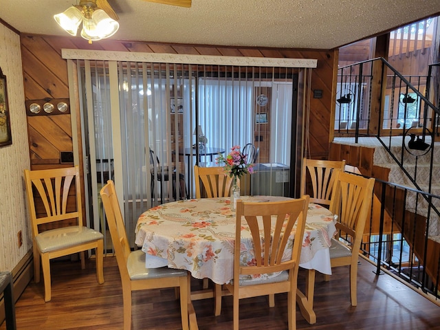 dining room featuring a textured ceiling and hardwood / wood-style flooring