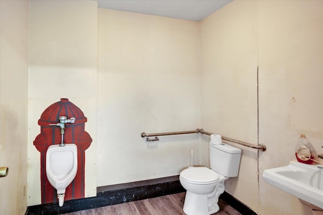 bathroom with toilet, wood-type flooring, and sink