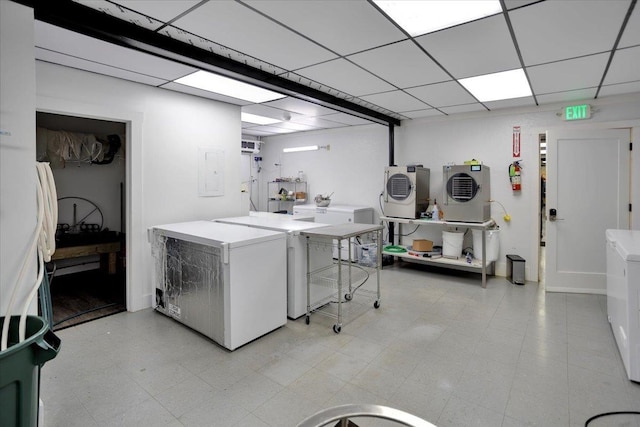 washroom with electric panel and washer and dryer