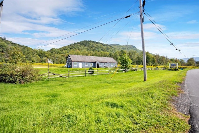 view of yard with a mountain view and a rural view