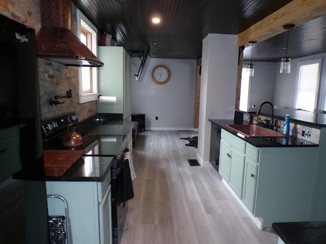 kitchen featuring range with electric cooktop, decorative light fixtures, light hardwood / wood-style flooring, premium range hood, and sink