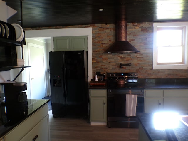 kitchen with range with electric cooktop, light wood-type flooring, black fridge, and white cabinets