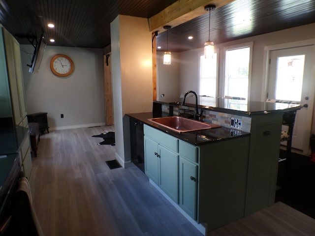 kitchen featuring dishwasher, dark wood-type flooring, a healthy amount of sunlight, and decorative light fixtures