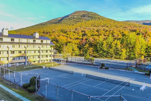 view of tennis court with a mountain view