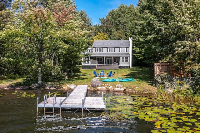 dock area featuring a yard and a water view