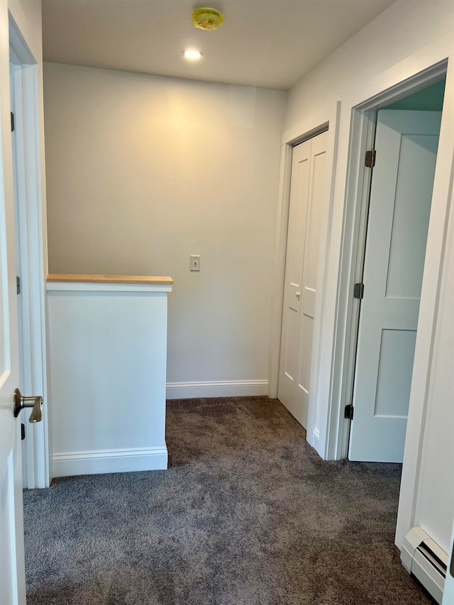 hall featuring dark carpet and a baseboard radiator