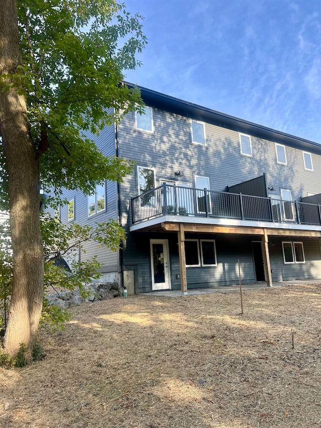 rear view of house featuring a deck