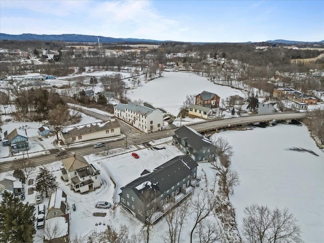 snowy aerial view featuring a mountain view