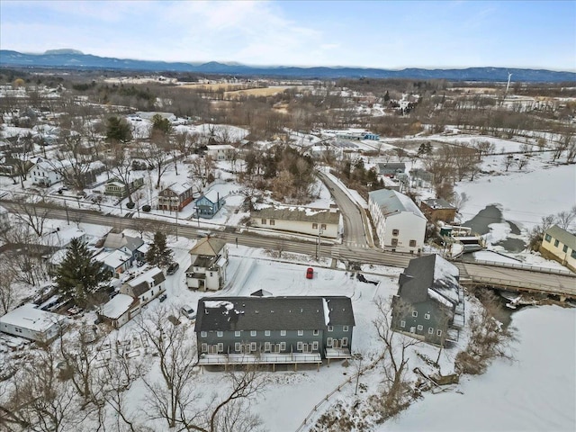 snowy aerial view featuring a mountain view