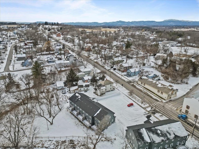 snowy aerial view with a mountain view