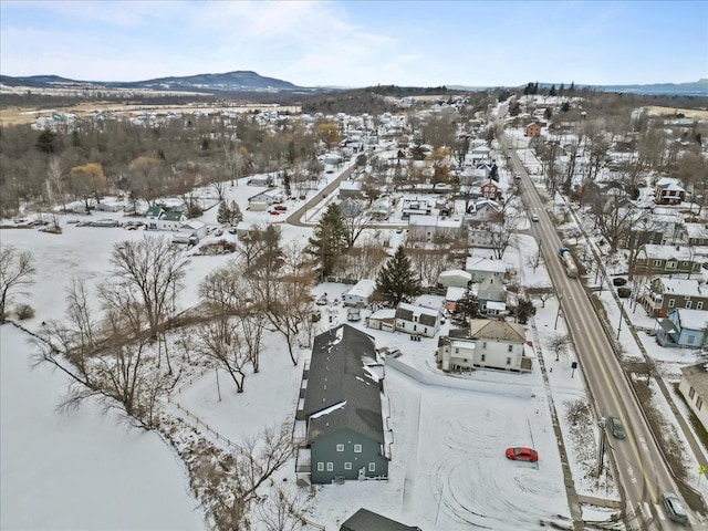 snowy aerial view featuring a mountain view