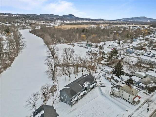 snowy aerial view with a mountain view