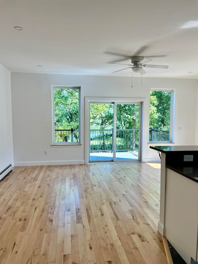 unfurnished living room with ceiling fan and light hardwood / wood-style floors