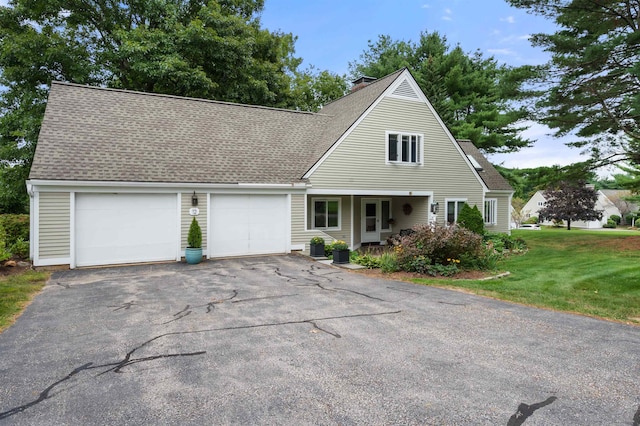 view of front of house featuring a garage and a front yard