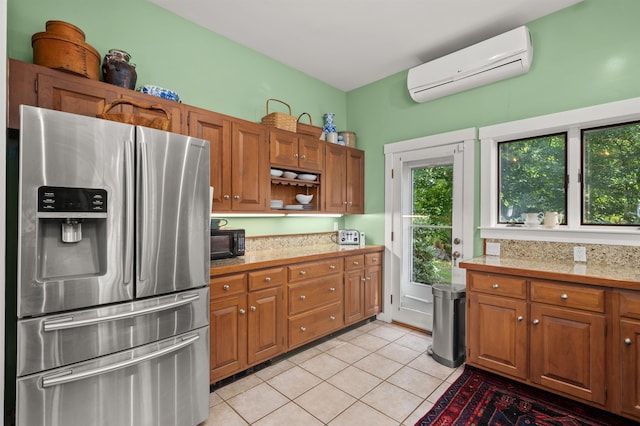 kitchen featuring light tile patterned floors, stainless steel fridge, and a wall unit AC