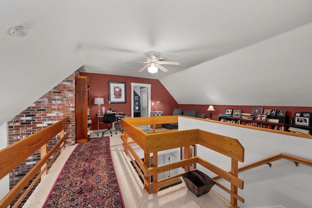 staircase with carpet flooring, ceiling fan, and vaulted ceiling