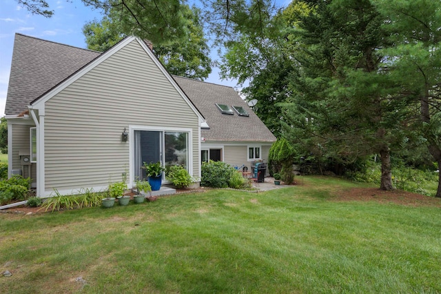 back of property featuring a lawn and a patio