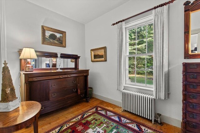 sitting room featuring radiator, plenty of natural light, and light hardwood / wood-style floors