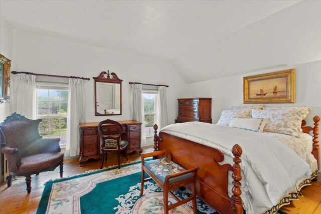 bedroom with lofted ceiling and hardwood / wood-style flooring