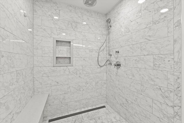 bathroom with a tile shower