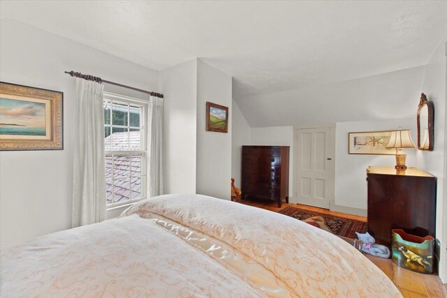 bedroom featuring lofted ceiling and wood-type flooring