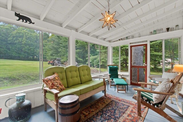 sunroom featuring lofted ceiling with beams and wood ceiling