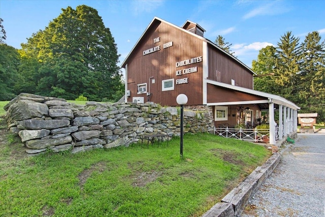 view of side of home featuring a lawn