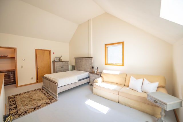 carpeted bedroom with baseboards and vaulted ceiling