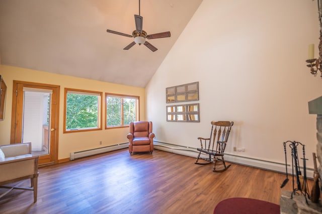 sitting room with baseboard heating, high vaulted ceiling, a ceiling fan, and wood finished floors