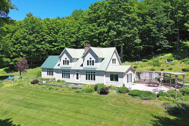 back of house featuring a patio and a lawn