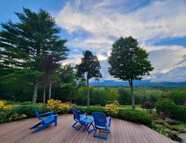 wooden deck featuring a mountain view