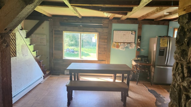 dining room featuring parquet flooring, beamed ceiling, and baseboard heating