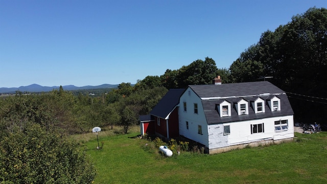 view of home's exterior featuring a mountain view and a yard