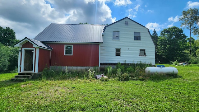 rear view of property with a yard