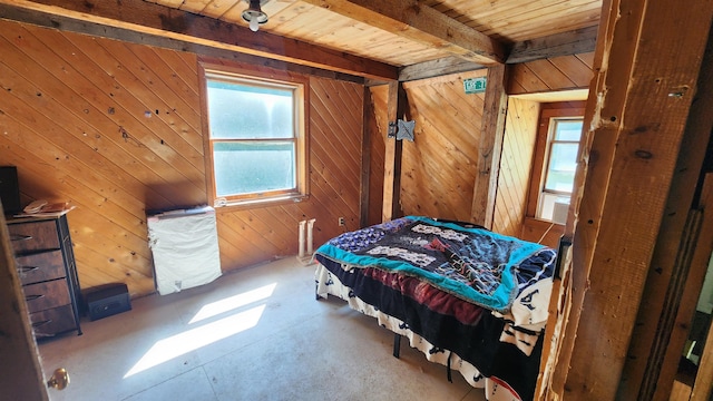 bedroom with wooden walls, wooden ceiling, and beamed ceiling