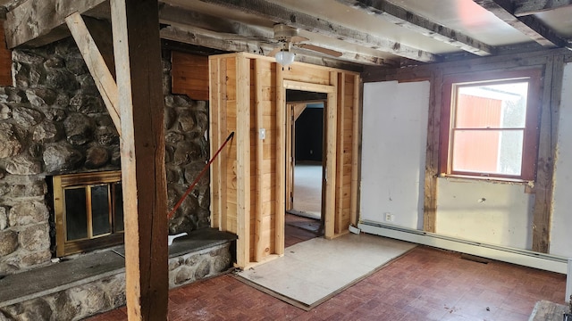 miscellaneous room with a baseboard radiator, ceiling fan, and a fireplace