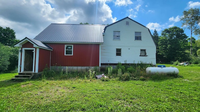 rear view of house with a yard