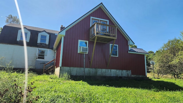 view of home's exterior featuring cooling unit and a balcony