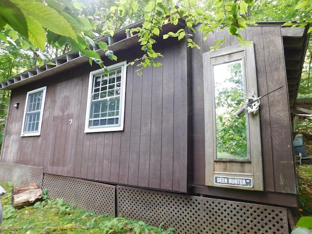 view of property exterior with an outbuilding