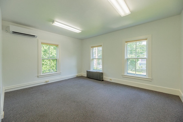 unfurnished room featuring radiator heating unit, dark colored carpet, an AC wall unit, and baseboards