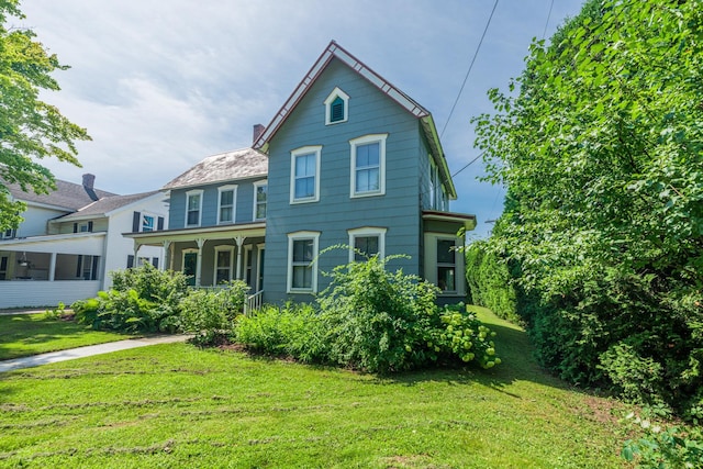 view of front of home featuring a front lawn and a chimney