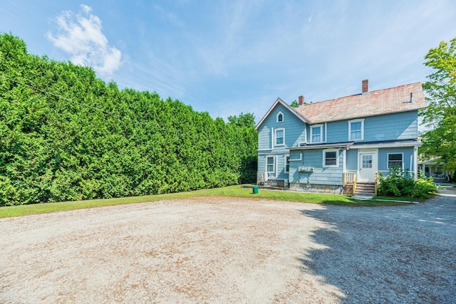 view of front of home featuring a chimney