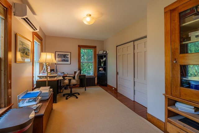 office space featuring baseboards, radiator heating unit, and a wall mounted air conditioner