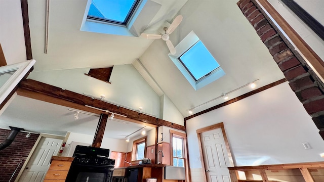 interior details featuring a wood stove, black gas range oven, and a skylight