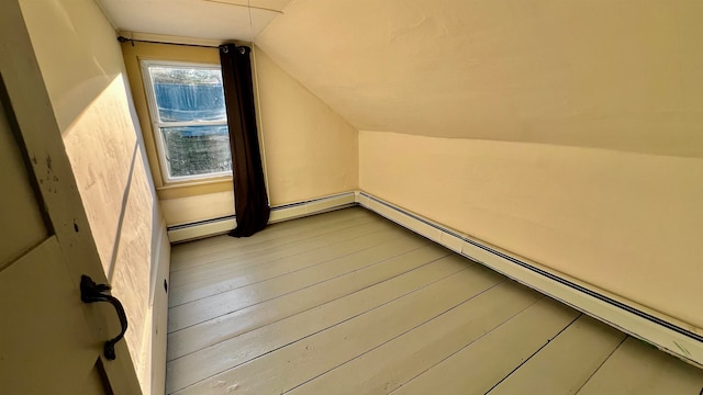 bonus room featuring lofted ceiling, hardwood / wood-style flooring, and a baseboard radiator